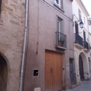 a building with a wooden door on the side of it at Chez René in Montagnac