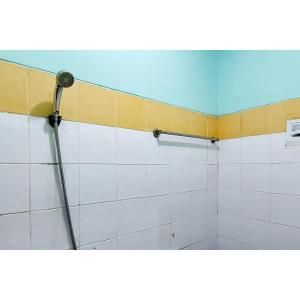 a bathroom with a shower with a shower at Surya Inn Syariah Cikarang RedPartner in Bekasi