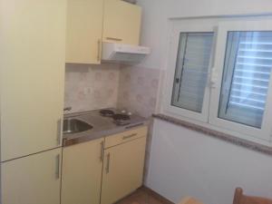 a small kitchen with a sink and a window at Apartmaji paliska a in Izola