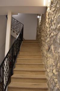 a staircase leading up to a building with a stone wall at La Casa del Campanar in Traiguera