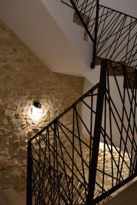 a staircase in a castle with a stone wall at La Casa del Campanar in Traiguera
