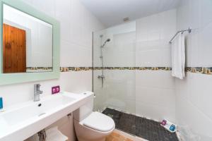 a bathroom with a sink and a toilet and a mirror at Comitas Tramontana Park in Fornells