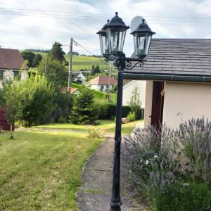 a black lamp post in front of a house at Maison charmante à Saint-Satur avec jardin et terrasse in Saint-Satur