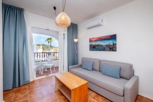 a living room with a couch and a table at Comitas Tramontana Park in Fornells