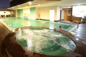 a large pool of water in a building at Park Lane Hotel in Lahore