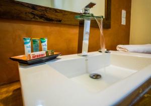 a bathroom sink with a faucet on top of it at Galavilla Boutique Hotel & Spa in Kandy