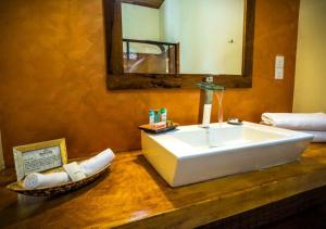 a bathroom with a large white sink and a mirror at Galavilla Boutique Hotel & Spa in Kandy
