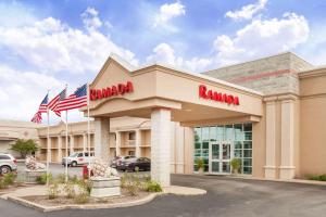 a ramaria store with american flags in front of it at Ramada by Wyndham Hammond Hotel & Conference Center in Hammond