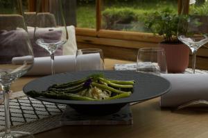 a plate of food with asparagus on a table at Hôtel Le Jeu de Paume in Chamonix