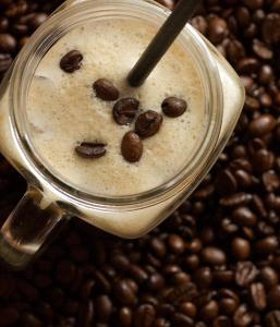 a glass jar filled with a drink on top of coffee beans at Hôtel Le Jeu de Paume in Chamonix +44 photos
