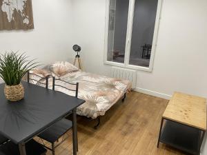 a living room with a table and a couch at Cadre idéal in Pantin