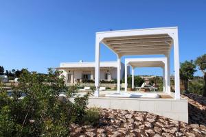 a white house with a pavilion in front of it at Villa Agata in Lido Marini