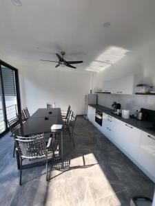 a kitchen with a table and chairs and a ceiling fan at Herzegovina Dream Residence in Stolac