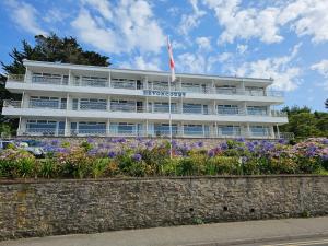 a building with flowers in front of it at Devoncourt Devoncoast SeaView Apartments in Brixham