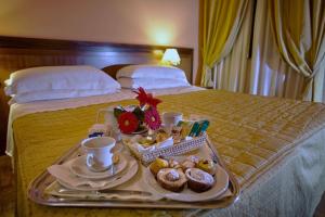 A bed or beds in a room at Best Western Hotel Ferrari