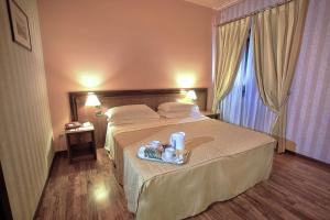 A bed or beds in a room at Best Western Hotel Ferrari