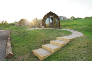 a set of stairs in a field with a gazebo at Cove Farm by Wigwam Holidays in Cockburnspath