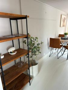 a living room with a book shelf and a table at Westerhuysje in Uitgeest