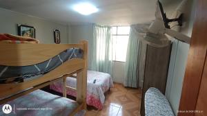 a bedroom with two bunk beds and a window at LUANA’S HOUSE in Ica