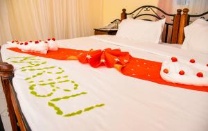 a bed with two hello kitty towels on it at Naivasha Peppercorn Holiday Resort in Naivasha