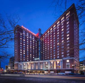 a hotel building with a lit up sign on it at Graduate by Hilton Providence in Providence