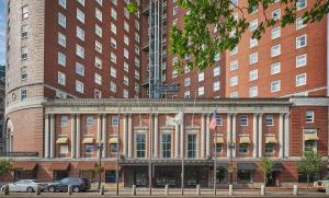 a large brick building with two american flags in front at Graduate by Hilton Providence in Providence
