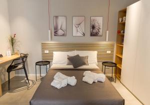 a bedroom with a bed with two towels on it at Porta San Paolo House in Castelbuono +38 photos