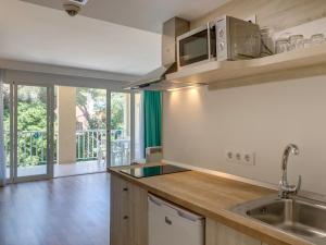 a kitchen with a sink and a counter top at Comitas Floramar in Cala Galdana