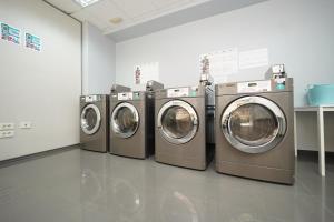 four washing machines are lined up in a room at Apartamentos RF Bambi Adults Only in Puerto de la Cruz