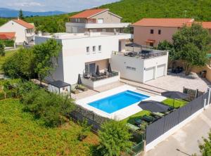 an aerial view of a house with a swimming pool at Villa Dreamin with Heated Pool & Hot Tub in Kraj