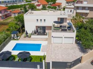 an aerial view of a house with a swimming pool at Villa Dreamin with Heated Pool & Hot Tub in Kraj