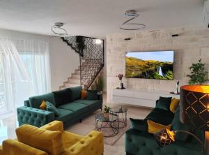 a living room with a green couch and a tv at Villa Dreamin with Heated Pool & Hot Tub in Kraj +45 photos