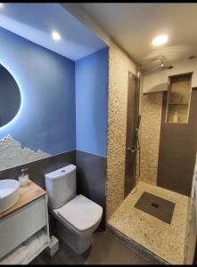a bathroom with a toilet and a sink and a shower at luzycolor Prohibido Fumar in Coslada