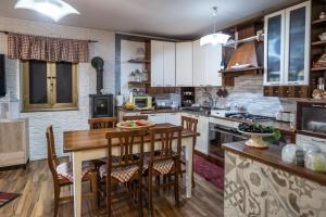 a kitchen with a wooden table and chairs at Villa aperta campagna in Nicosia
