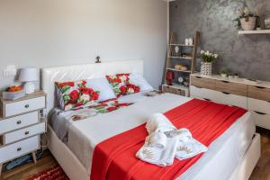 a bedroom with a white bed with a red blanket at Villa aperta campagna in Nicosia