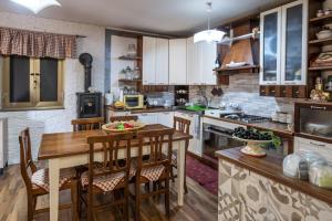 a kitchen with a wooden table and some chairs at Villa aperta campagna in Nicosia