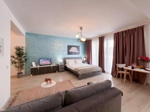 a large living room with a bed and a couch at Central Luxury SOHO Unirii Old City Free minibar in Bucharest