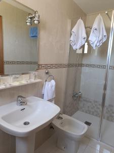 a bathroom with a sink and a shower and a toilet at Hotel Santa María in Palos de la Frontera +36 photos
