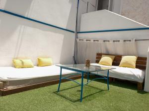 a room with two beds and a glass table at Palmera by LOREN VILLAGE in Neve Zohar