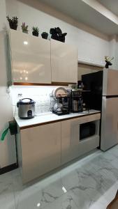a kitchen with a stove and a refrigerator at holiday suratthani in Suratthani +8 photos