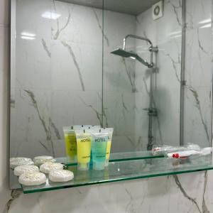 a glass shelf in a bathroom with toiletries and a mirror at Eco House in Gyumri +28 photos