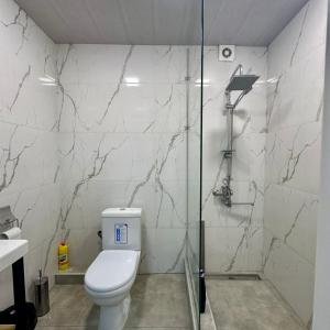a bathroom with a toilet and a glass shower at Eco House in Gyumri