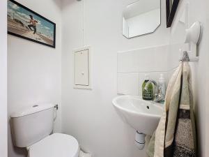 a white bathroom with a toilet and a sink at Classy T3 with terrace in Saint-Ouen +8 photos