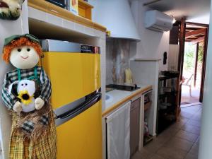 a kitchen with a toy person holding a teddy bear at Casa Marilena vista mare in Sperlonga