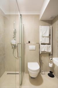 a bathroom with a toilet and a glass shower at Hotel Hermes Budva in Budva