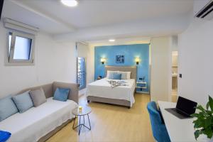 a living room with a bed and a couch at Hotel Hermes Budva in Budva