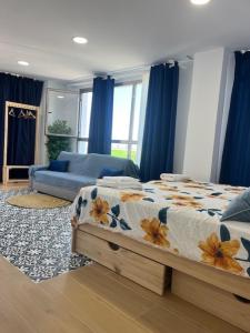 a bedroom with a bed and a couch at ALZIRA BONiTA LES BARRAQUES LOFT in Alzira