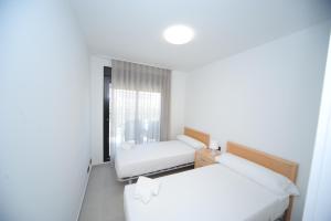a room with two beds and a window at ATICO BOHIO premium in Benicàssim