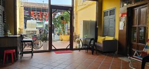 a patio with a table and a dog looking out the door at The Century Aigoh Hotel in George Town