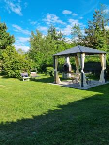 a gazebo with a table and chairs in a park at Villa Anna in Sorico